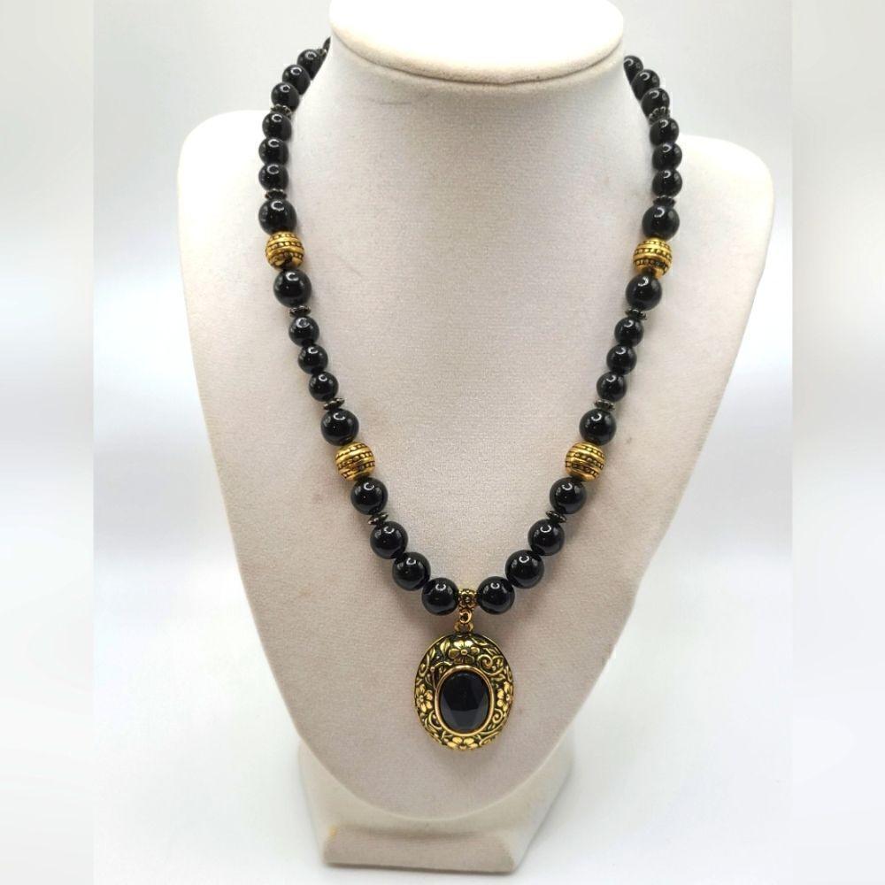 Onyx necklace with goldtone pendant.